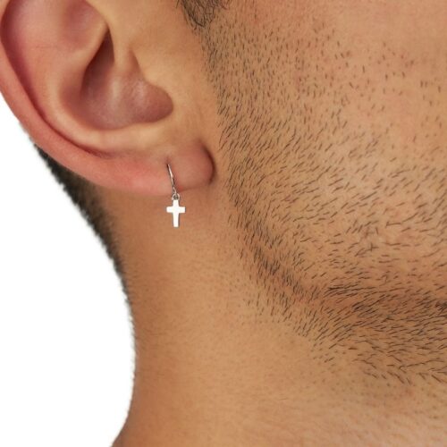 Close up of a cross ear ring for men wore by a male model on a white background by Isa Aydin NJ NY LA