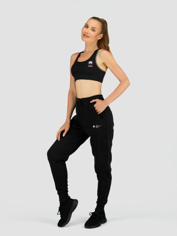 Clothing photography of a female white model wearing sports suit in black