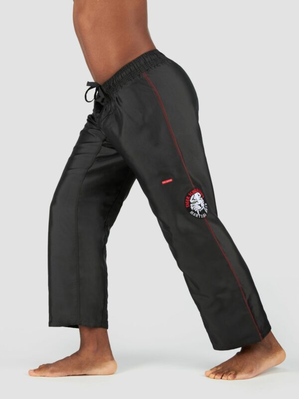 Product shot of male model wearing sports pants in black