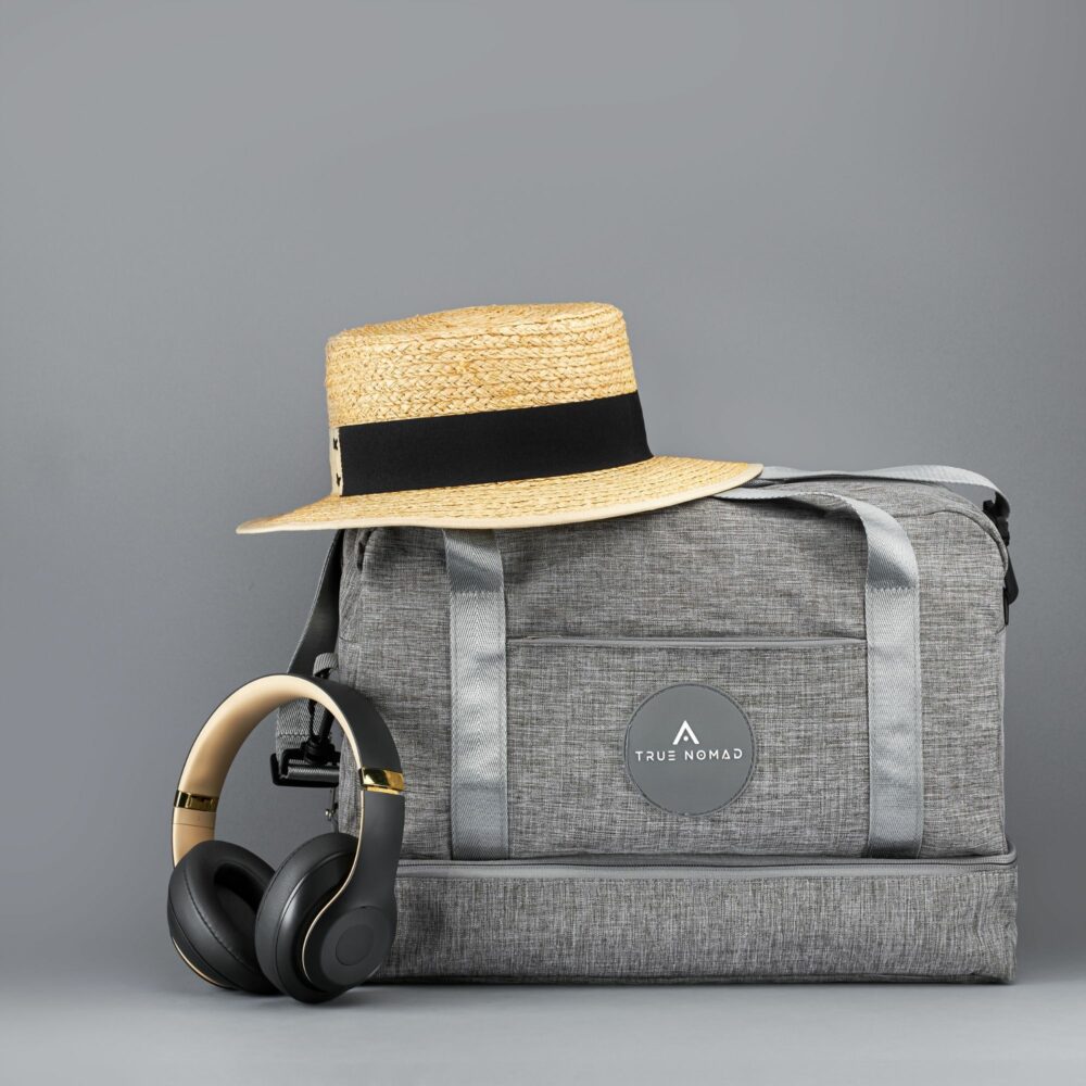 Skin colored textured hat with black strip placed on a travel bag by Isa Aydin NJ NY LA