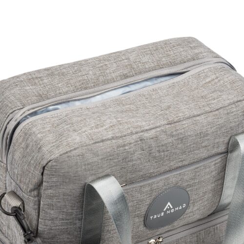 Closeup shot of a lucid grey colored travel bag with opened zip on a white background by Isa Aydin nj ny la