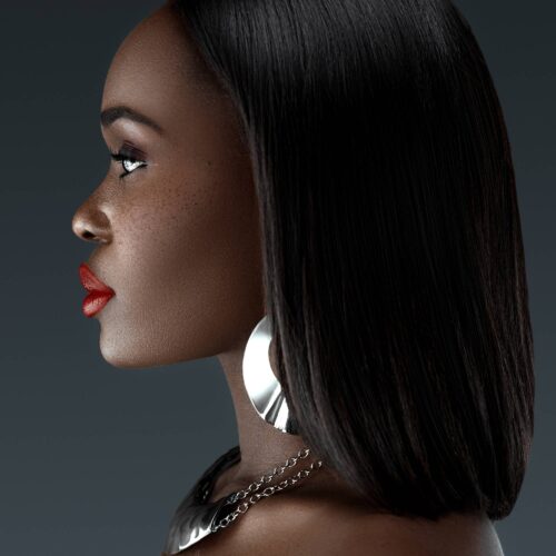 Beauty shot of a black female model with short hairs wearing jewelry. Beauty photography by photographer Isa Aydin.