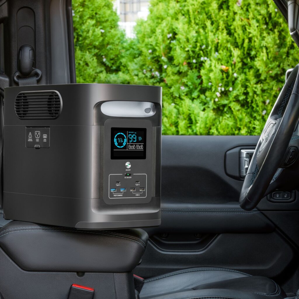 ChatGPT A portable solar power bank generator is prominently displayed on the passenger seat of a vehicle, showcasing its convenience and ease of use for on-the-go energy needs, against a lush greenery seen through the car window.